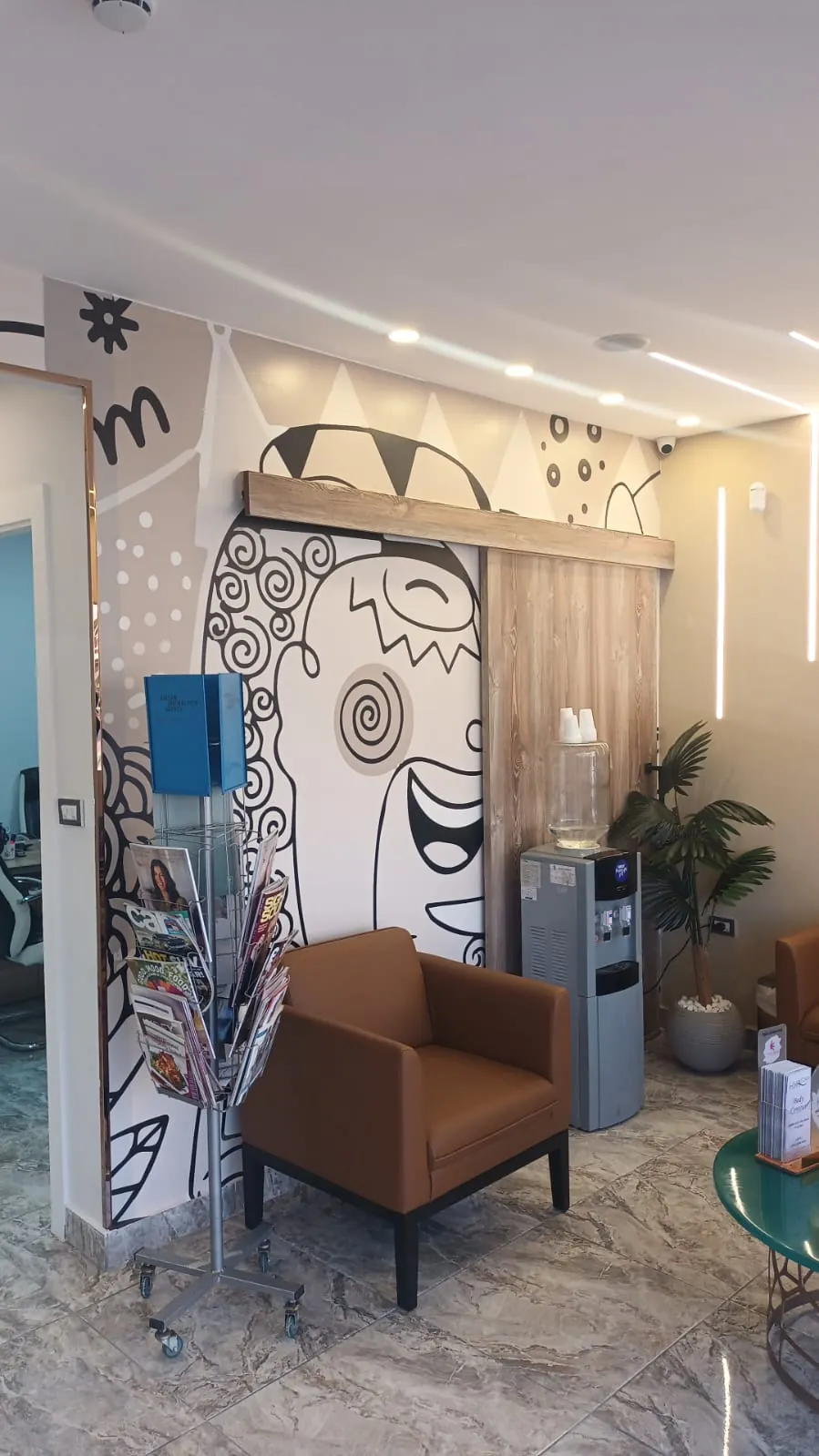 Client lounge with hand-painted mural at Gala Clinics Amman